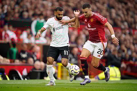 English Premier League 2024-25 Liverpool vs Manchester United: Liverpool's Mohamed Salah, left, challenges for the ball with Manchester United's Diogo Dalot